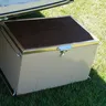 Cooler with its lid open on grass (illustrative photo)