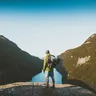 Hiker with a backpack on a rocky ridge (illustrative photo)