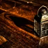 Metal lantern on a wooden table (illustrative photo)