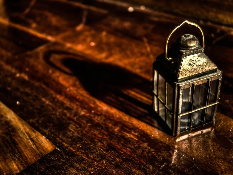 Metal lantern on a wooden table (illustrative photo)