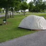 Grey dome tent on a lawn at a campground (illustrative photo)