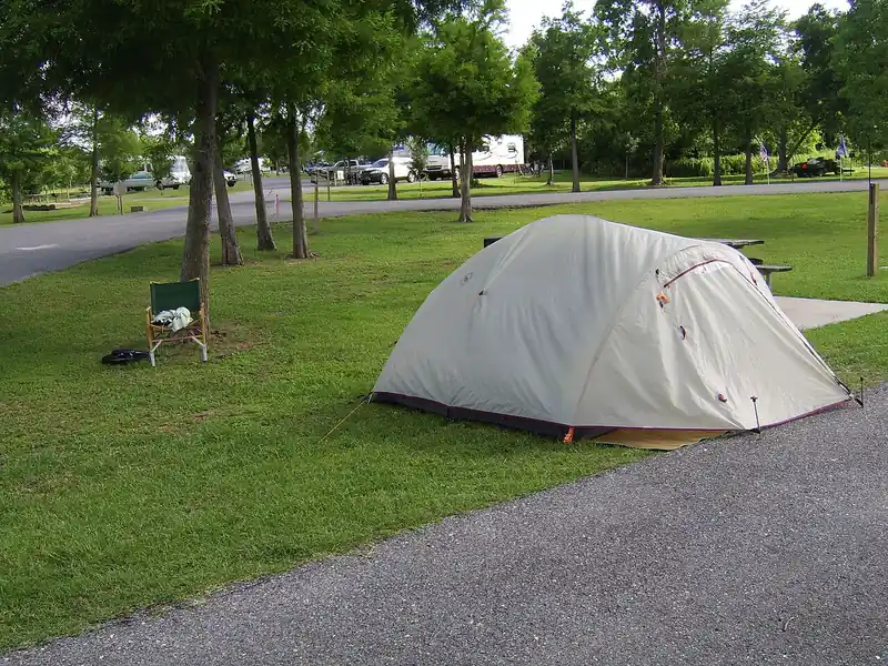 Grey dome tent on a lawn at a campground (illustrative photo)