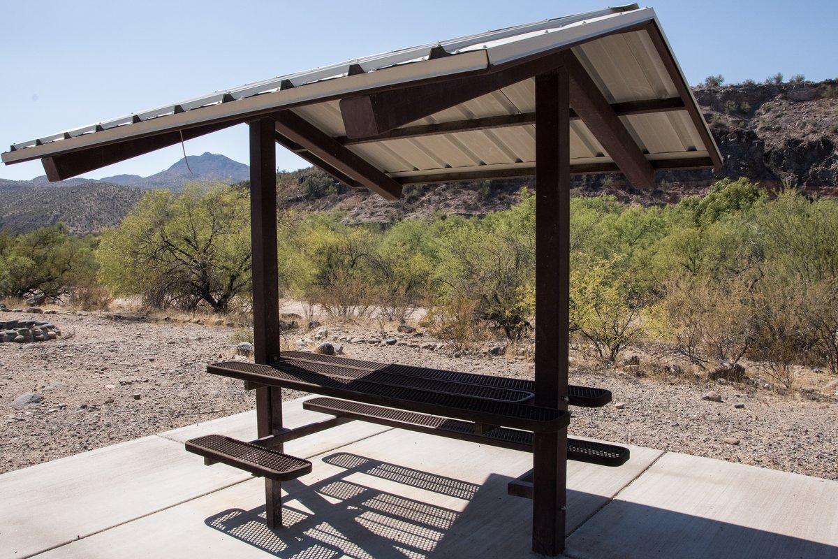 Picnic table at a shaded desert campground site