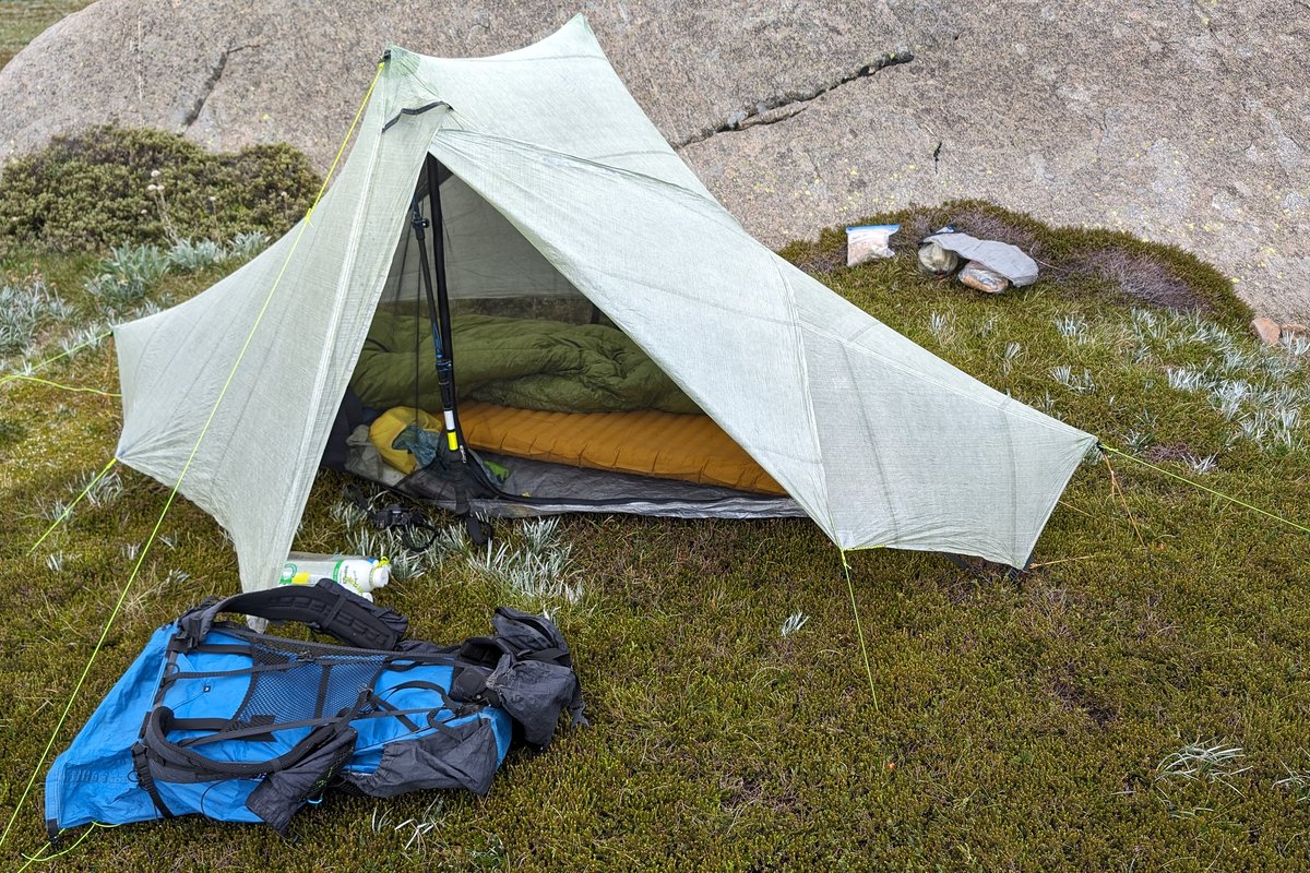 Backpacking tent with sleeping bag and backpack on the ground