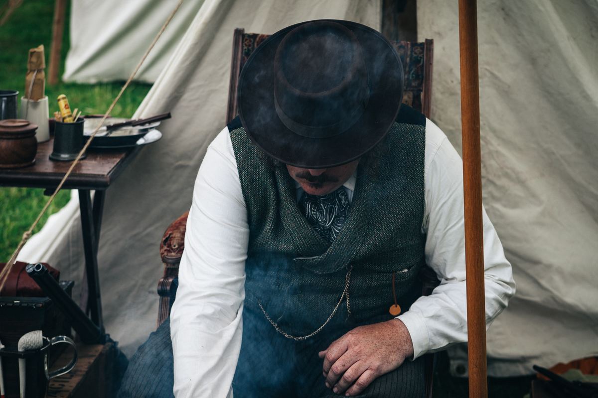 Illustrative photo of a person sitting inside a roomy camping tent