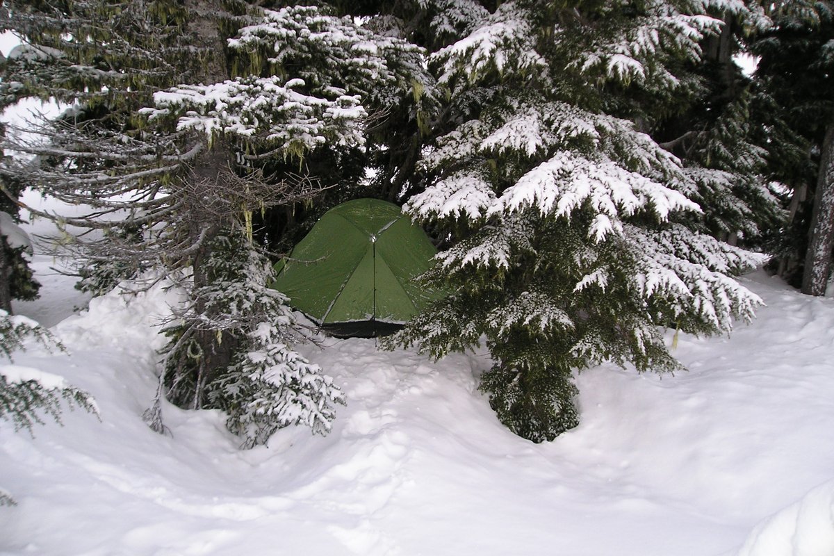Illustrative photo of a tent pitched in a snowy winter backcountry camp