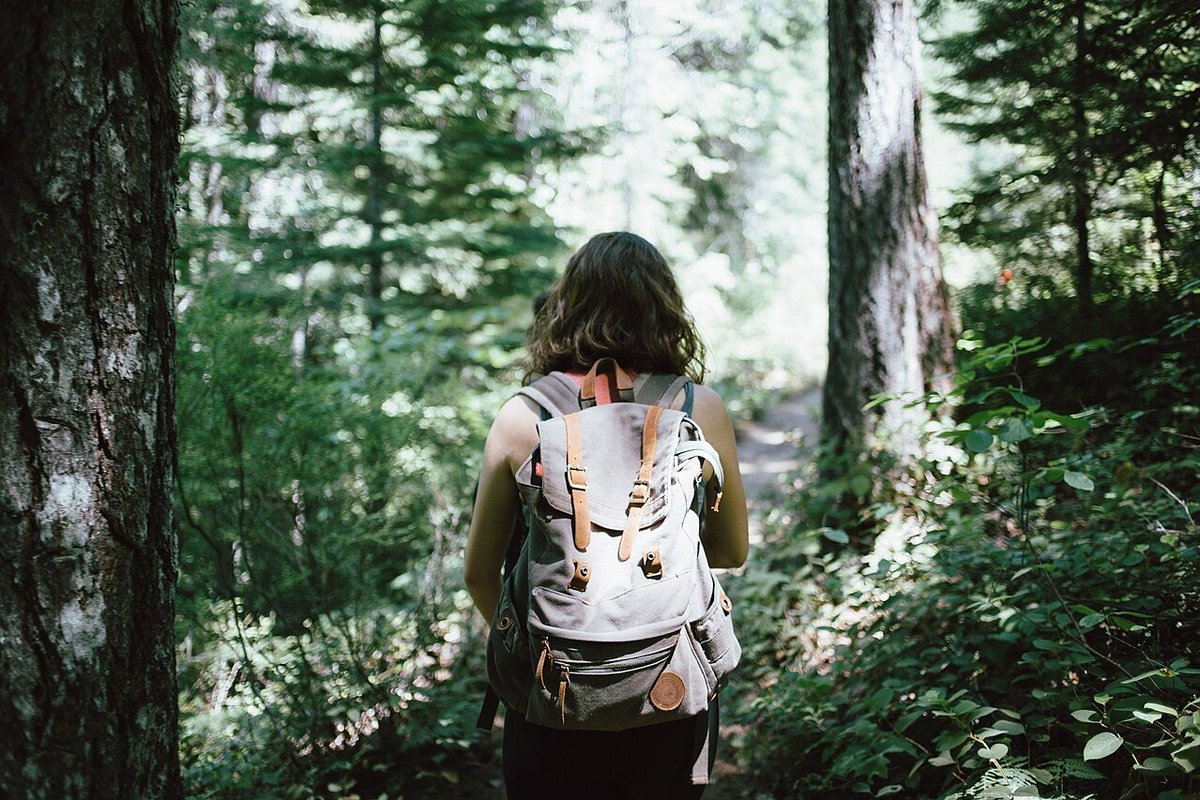 Illustrative photo of a hiker carrying a large backpack outdoors