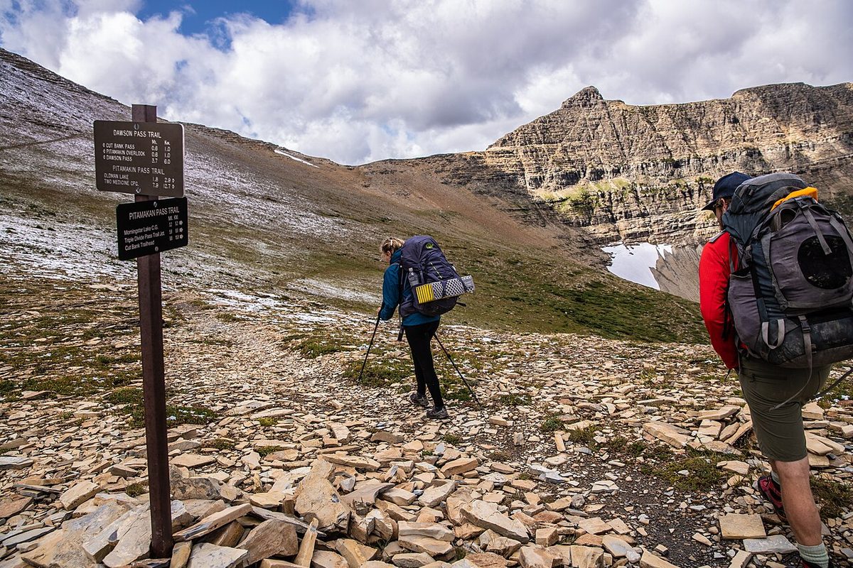 Illustrative photo of backpackers walking in the mountains